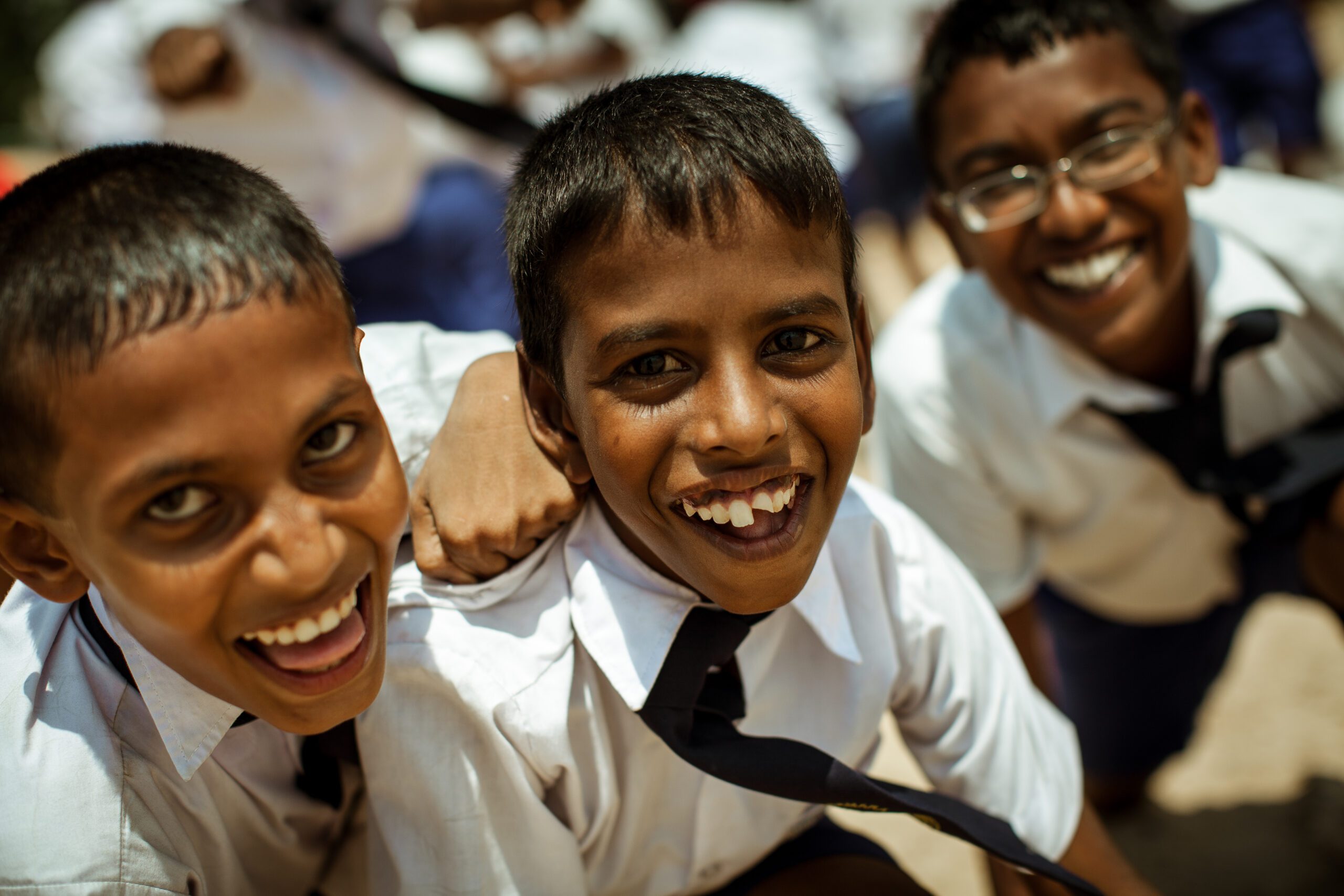 School children dressed in uniform have fun and play in the schoolyard. Wadduwa, Sri-Lanka.